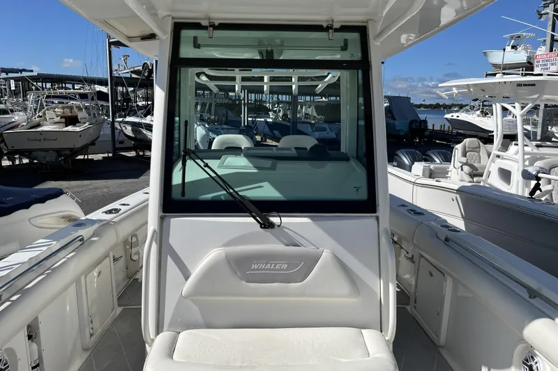 Slide: The Image of 2012 Boston Whaler 320 Outrage boat docked at marina, front view. - 9