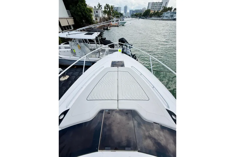 Slide: The Image of 2021 Intrepid 410 Evolution yacht docked in a scenic marina setting. - 10