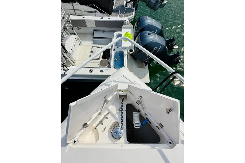 Slide: The Image of Intrepid 410 Evolution 2021 boat with open storage compartment and dual outboard engines. - 12