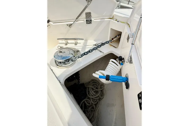 Slide: The Image of Anchor compartment of 2021 Intrepid 410 Evolution boat with chain and coiled hose. - 13