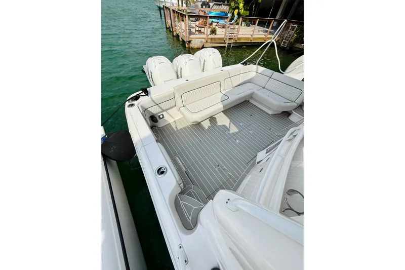 Slide: The Image of 2021 Intrepid 410 Evolution boat deck with seating, docked by clear water. - 15