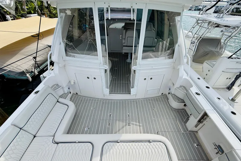 Slide: The Image of 2021 Intrepid 410 Evolution boat interior with sleek seating and modern design. - 18