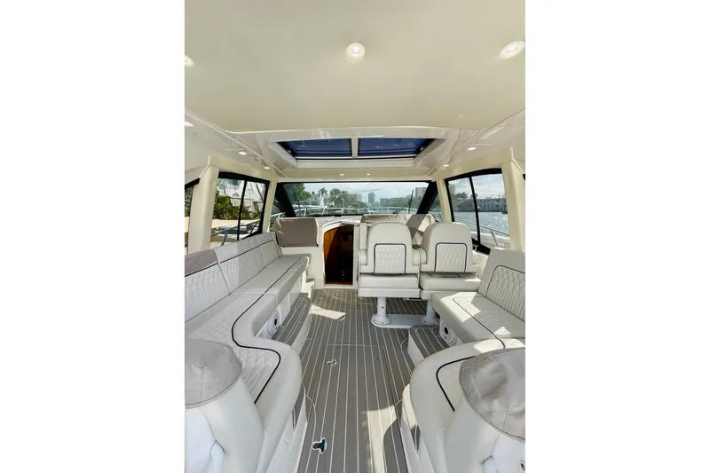 Slide: The Image of 2021 Intrepid 410 Evolution yacht interior with luxurious seating and panoramic windows. - 20