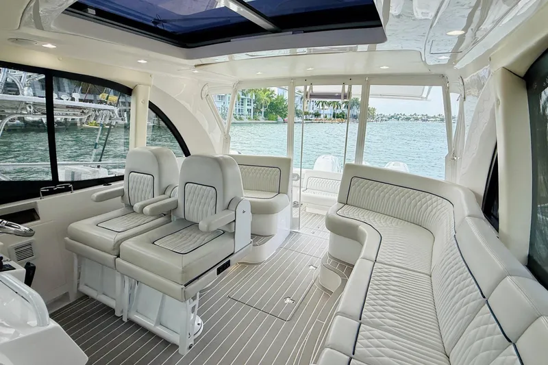 Slide: The Image of Luxurious interior of 2021 Intrepid 410 Evolution yacht with plush seating and scenic water view. - 25