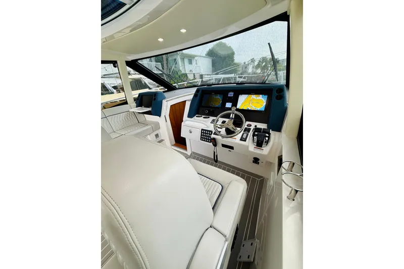 Slide: The Image of Luxurious 2021 Intrepid 410 Evolution yacht cockpit with advanced navigation systems and plush seating. - 26