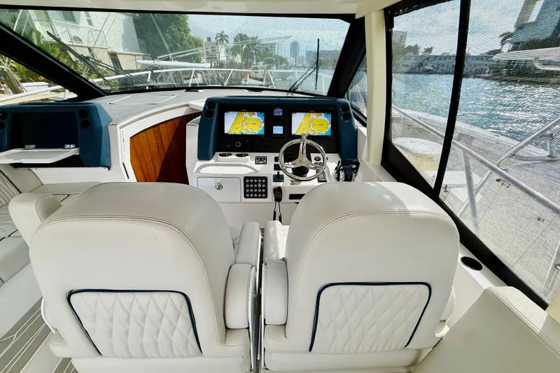 Slide: The Image of Luxury helm of 2021 Intrepid 410 Evolution yacht with modern navigation displays. - 27
