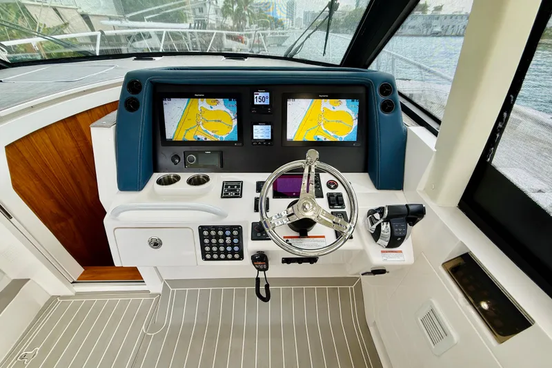 Slide: The Image of 2021 Intrepid 410 Evolution helm with dual navigation screens and modern controls. - 29