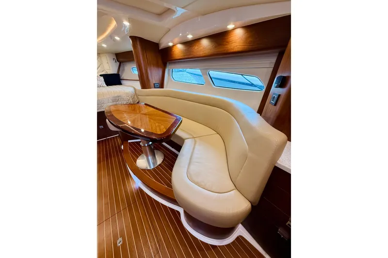 Slide: The Image of Luxurious interior of 2021 Intrepid 410 Evolution yacht with elegant seating and wooden table. - 39