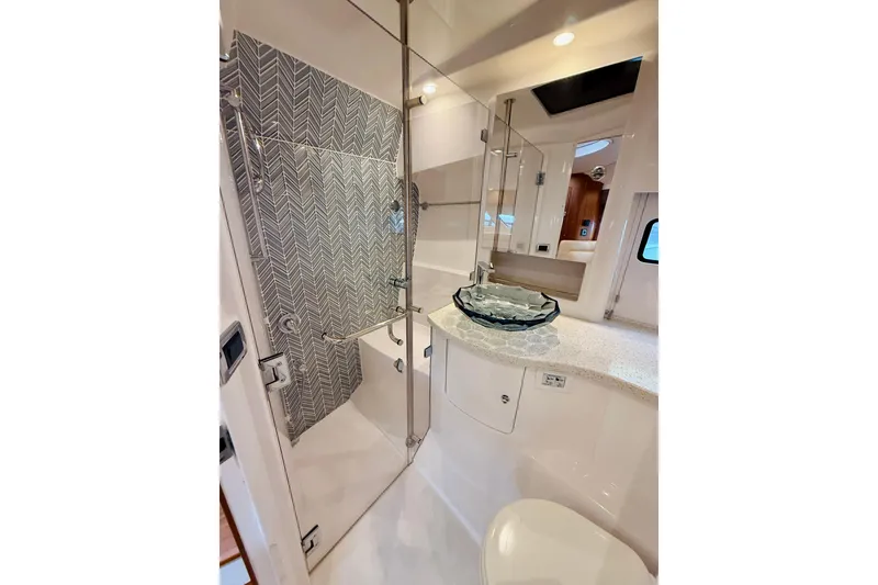 Slide: The Image of Luxurious bathroom in 2021 Intrepid 410 Evolution yacht with glass sink and modern shower. - 46