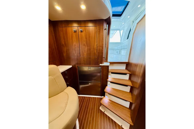 Slide: The Image of Luxurious interior of 2021 Intrepid 410 Evolution yacht with wooden stairs and seating. - 47