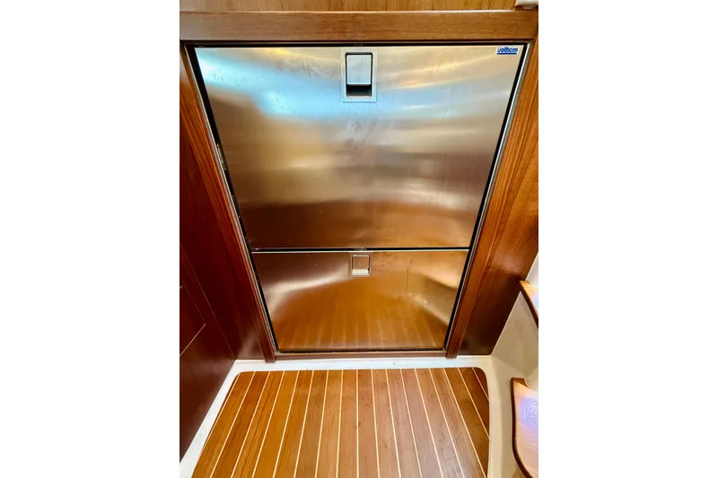 Slide: The Image of Stainless steel refrigerator on 2021 Intrepid 410 Evolution yacht with wooden flooring. - 48