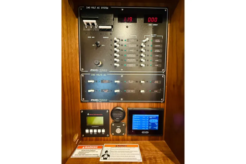 Slide: The Image of 2021 Intrepid 410 Evolution electrical control panel with digital displays and warning labels. - 49