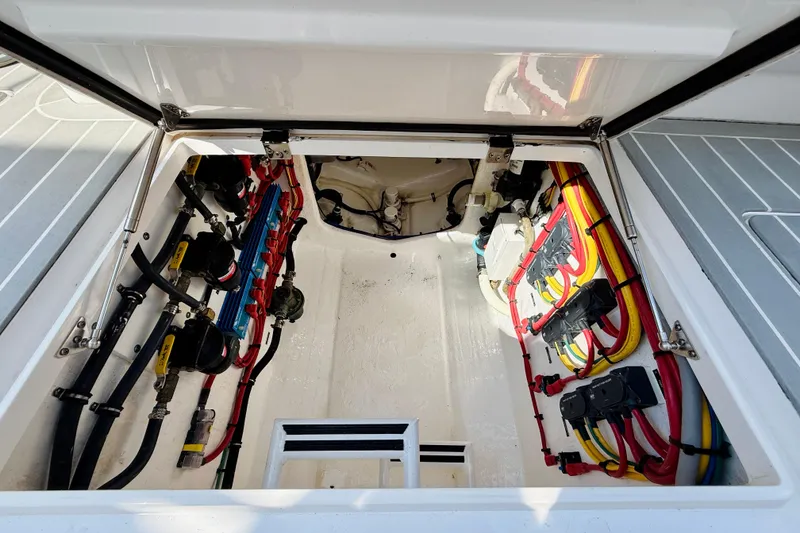 Slide: The Image of Engine compartment of a 2021 Intrepid 410 Evolution boat, showcasing wiring and components. - 50