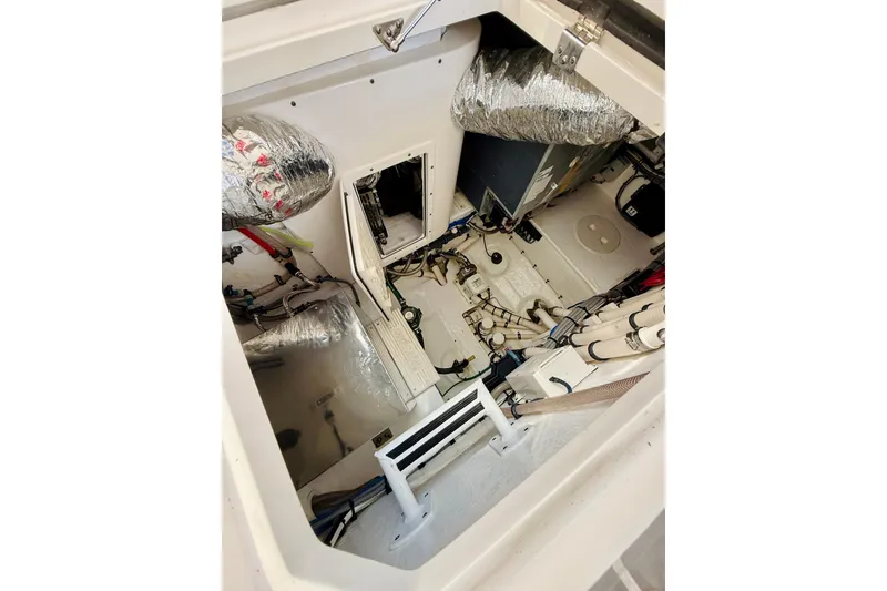 Slide: The Image of Engine compartment of 2021 Intrepid 410 Evolution boat, showcasing mechanical components and insulation. - 52