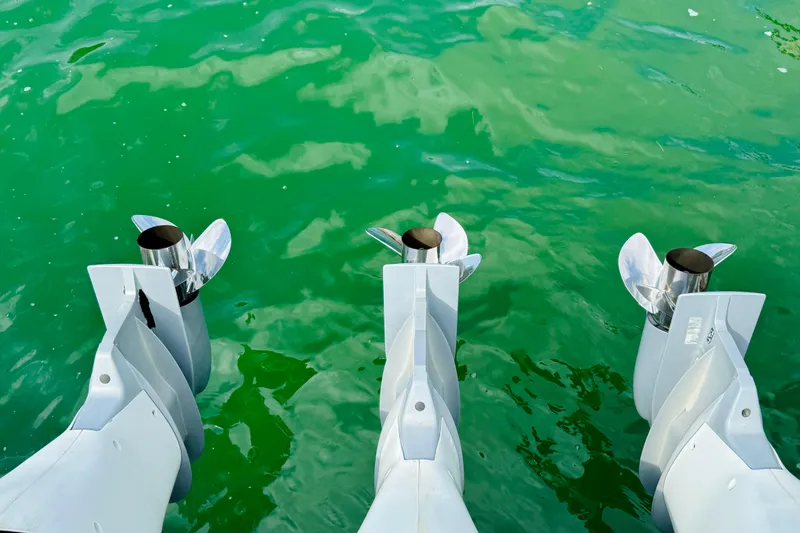 Slide: The Image of Triple outboard motors on a 2021 Intrepid 410 Evolution in green water. - 55