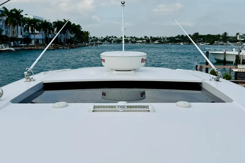 Slide: The Image of 2021 Intrepid 410 Evolution yacht on a scenic waterway with palm trees. - 9