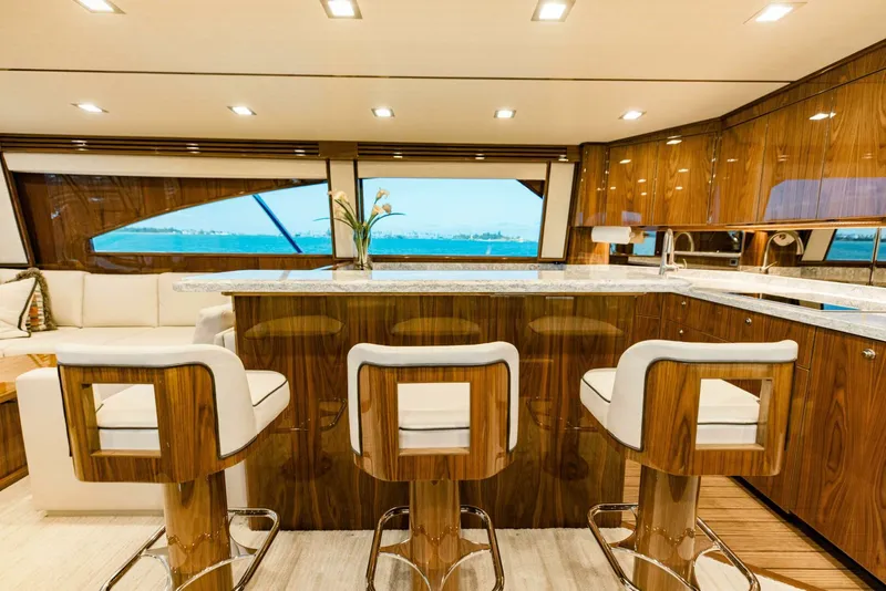 Slide: The Image of Luxurious interior of 2020 Viking 72 yacht with elegant bar stools and panoramic windows. - 10