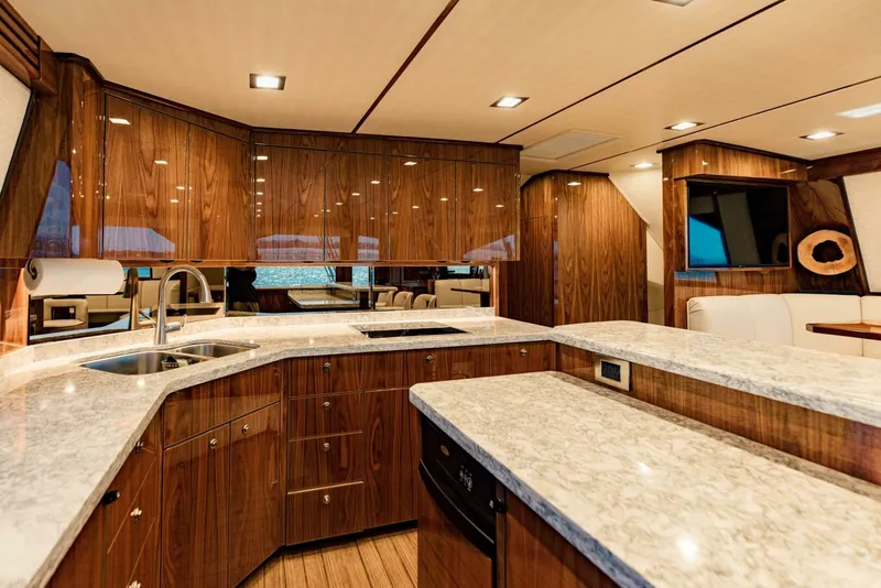 Slide: The Image of Luxurious 2020 Viking 72 yacht interior with modern kitchen and elegant wood finishes. - 11
