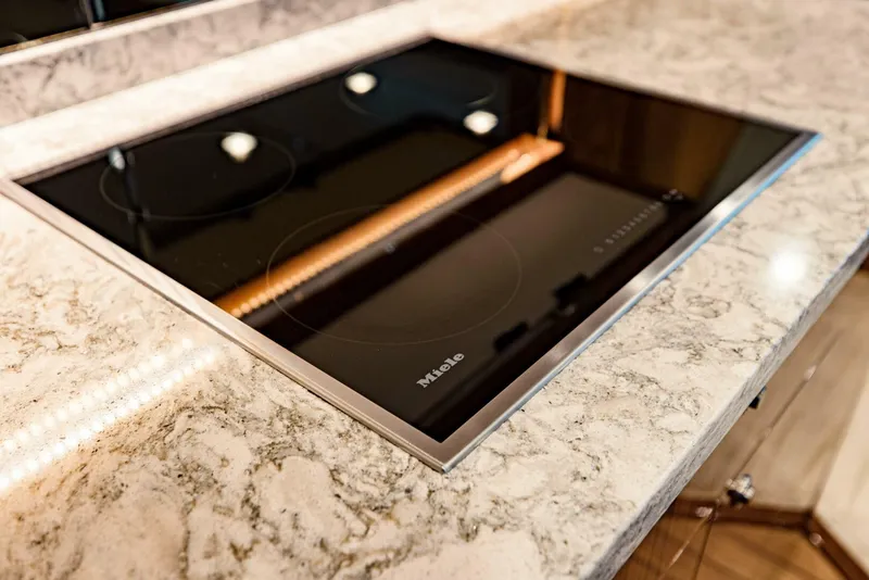 Slide: The Image of Modern kitchen with Miele induction cooktop on marble countertop, Viking 72, 2020 model. - 13