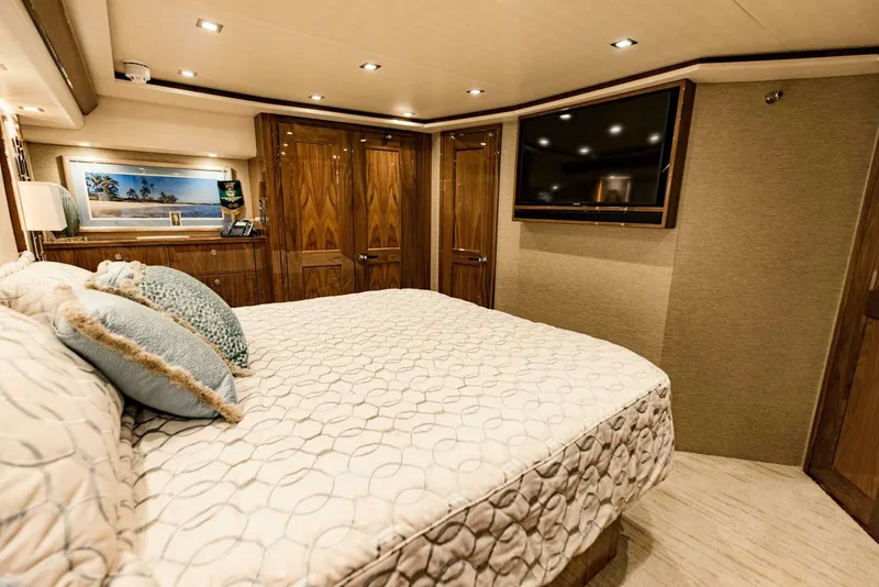 Slide: The Image of Luxurious bedroom interior of 2020 Viking 72 yacht with elegant wood finishes and modern amenities. - 17
