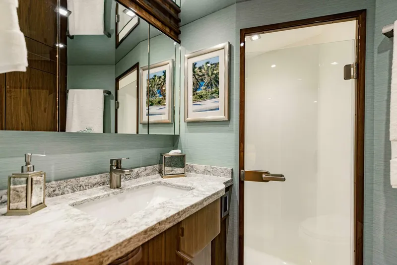 Slide: The Image of Luxurious bathroom in 2020 Viking 72 yacht with marble countertop and glass shower door. - 19
