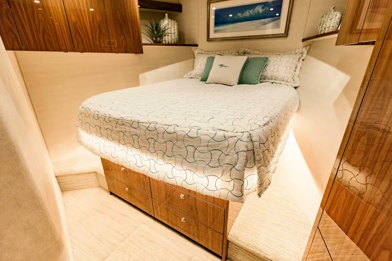 Slide: The Image of Luxurious bedroom interior of 2020 Viking 72 yacht with elegant bedding and wooden cabinetry. - 22