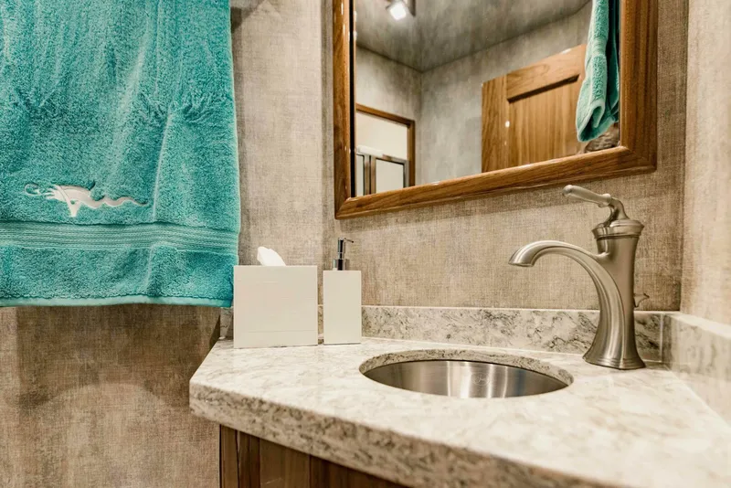 Slide: The Image of Modern bathroom in 2020 Viking 72 yacht with marble countertop and teal towel. - 26