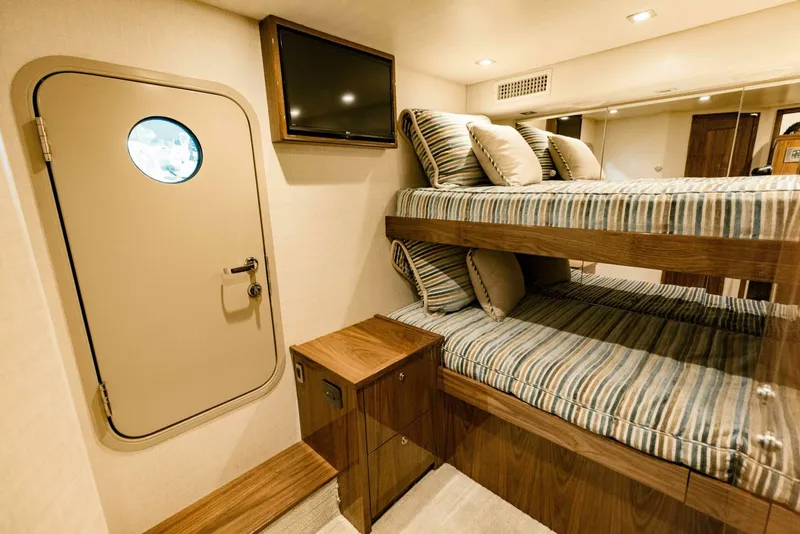 Slide: The Image of Luxurious 2020 Viking 72 yacht cabin with bunk beds and modern decor. - 37