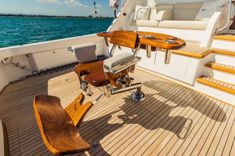 Slide: The Image of Luxurious 2020 Viking 72 yacht deck with polished wood seating and ocean view. - 41