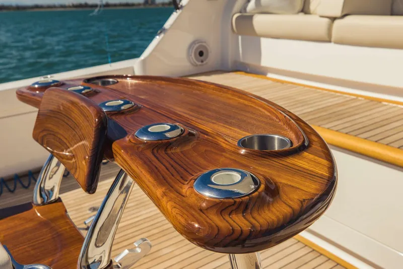 Slide: The Image of Luxurious wooden deck table on a 2020 Viking 72 yacht, overlooking the ocean. - 44