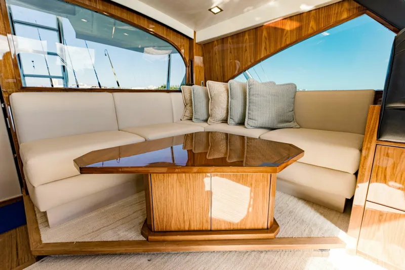Slide: The Image of Luxurious interior of 2020 Viking 72 yacht with plush seating and elegant wooden table. - 49