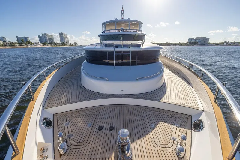 Slide: The Image of Luxurious 2003 Johnson 87' Motor Yacht on serene waters, cityscape in background. - 18