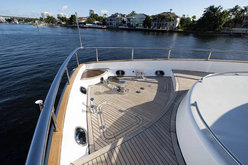Slide: The Image of 2003 Johnson 87' Motor Yacht deck with scenic waterfront view. - 19
