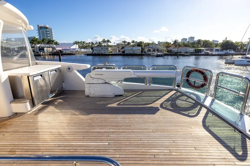 Slide: The Image of Luxurious 2003 Johnson 87' Motor Yacht deck with scenic waterfront view. - 21