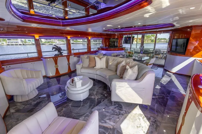 Slide: The Image of Luxurious interior of a 2003 Johnson 87' Motor Yacht with elegant seating and modern decor. - 23