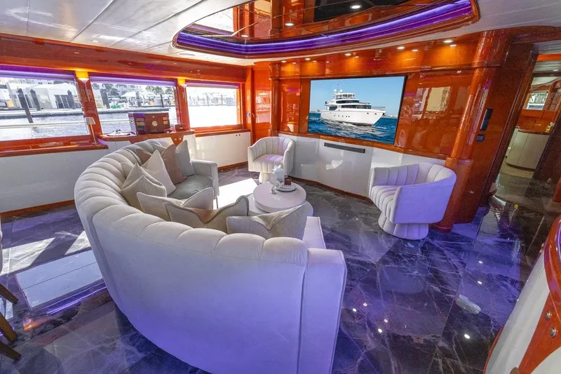 Slide: The Image of Luxurious interior of 2003 Johnson 87' Motor Yacht with plush seating and large TV. - 25