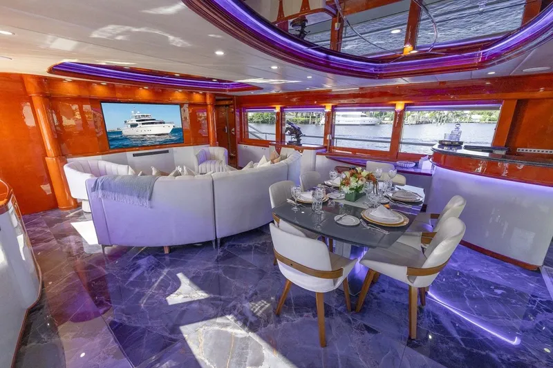 Slide: The Image of Luxurious interior of 2003 Johnson 87' Motor Yacht with elegant dining and seating area. - 26