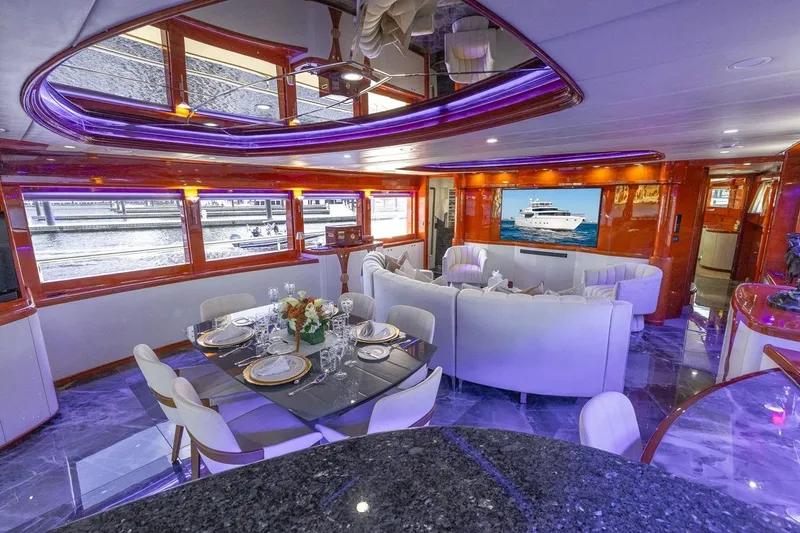 Slide: The Image of Luxurious interior of a 2003 Johnson 87' Motor Yacht with elegant dining and seating areas. - 27