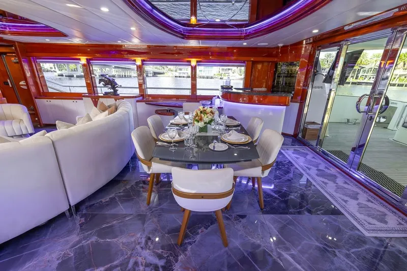 Slide: The Image of Luxurious interior of a 2003 Johnson 87' Motor Yacht with elegant dining setup and modern decor. - 28