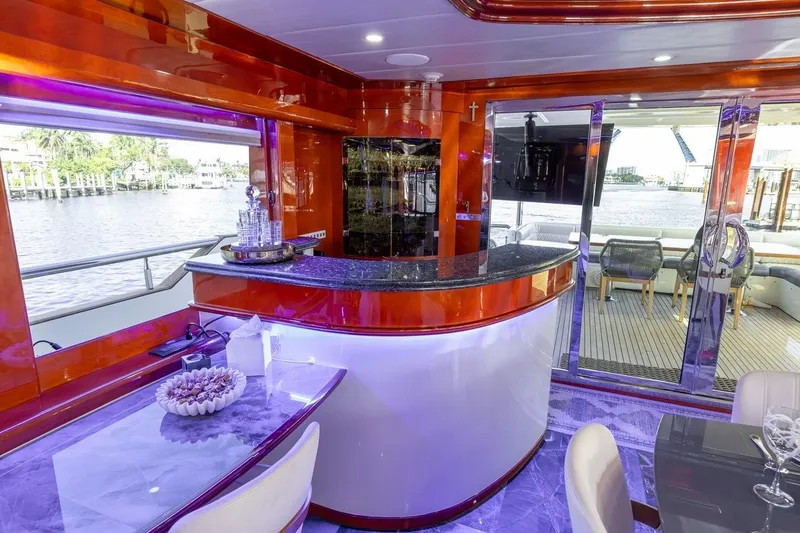 Slide: The Image of Luxurious interior of a 2003 Johnson 87' Motor Yacht with elegant bar and waterfront view. - 30