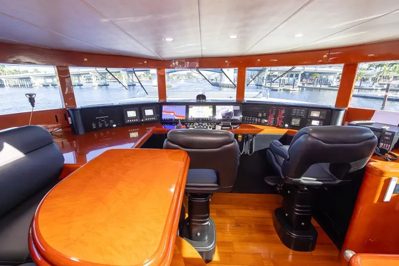 Slide: The Image of Luxurious helm of 2003 Johnson 87' Motor Yacht with modern navigation equipment. - 31