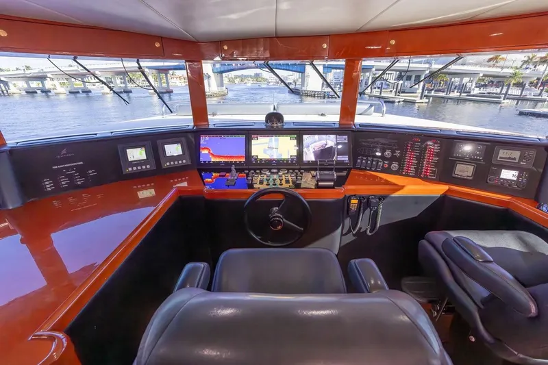 Slide: The Image of Cockpit of 2003 Johnson 87' Motor Yacht with advanced navigation systems and waterfront view. - 32