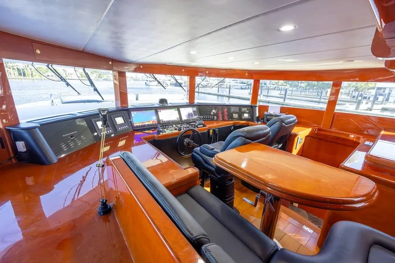 Slide: The Image of Luxurious helm of 2003 Johnson 87' Motor Yacht with polished wood and advanced navigation systems. - 34