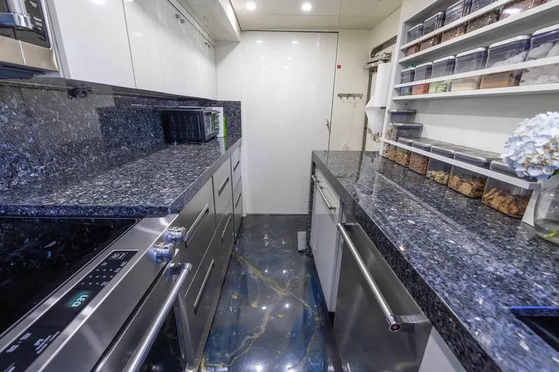 Slide: The Image of Luxurious kitchen in 2003 Johnson 87' Motor Yacht with granite countertops and modern appliances. - 35