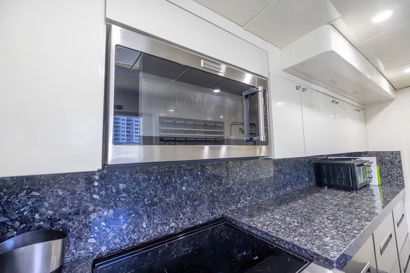 Slide: The Image of Modern kitchen in 2003 Johnson 87' Motor Yacht with granite countertops and stainless steel appliances. - 36