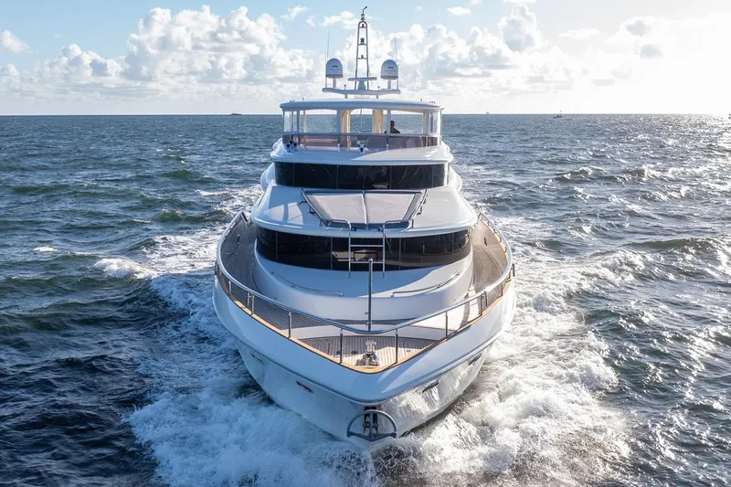 Slide: The Image of Luxurious 2003 Johnson 87' Motor Yacht cruising on open sea under clear skies. - 4