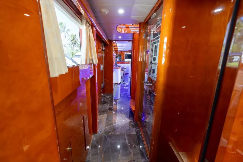 Slide: The Image of Luxurious interior hallway of a 2003 Johnson 87' Motor Yacht with polished wood finishes. - 40