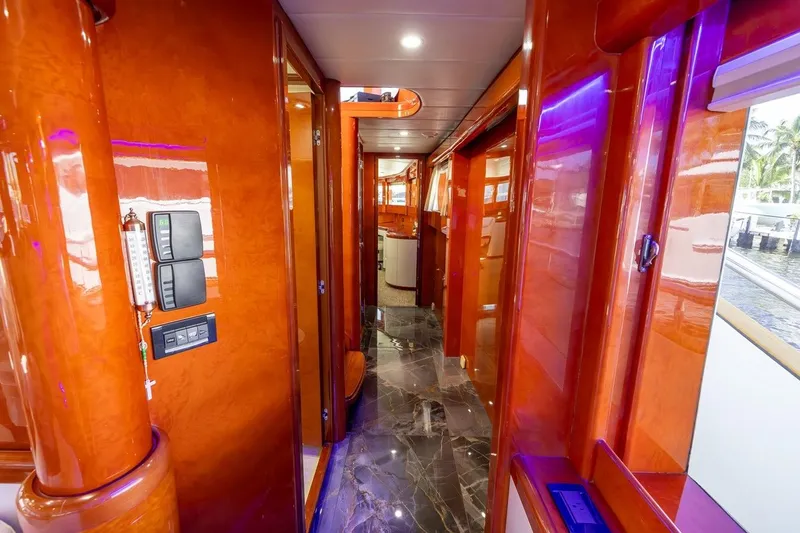 Slide: The Image of Luxurious interior hallway of 2003 Johnson 87' Motor Yacht with glossy wood finish. - 41