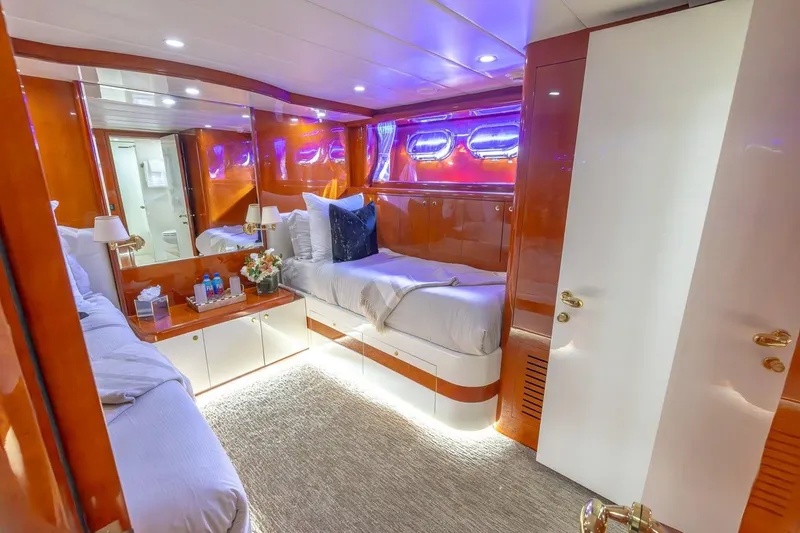 Slide: The Image of Luxurious cabin interior of a 2003 Johnson 87' Motor Yacht with elegant wood finishes. - 42