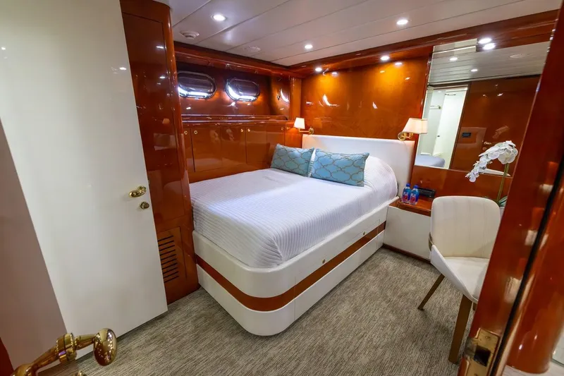 Slide: The Image of Luxurious bedroom interior on a 2003 Johnson 87' Motor Yacht, featuring elegant wood paneling. - 45